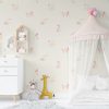 Pink puppy dog wallpaper for kids in beige kids' playroom.