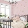 Pink puppy dog wallpaper in girls' bedroom.
