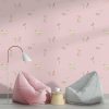 Pink puppy dog wallpaper in kids' playroom.