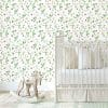 Charming strawberry field floral wallpaper adds a fresh, nature-inspired touch to a girl's baby nursery.