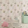 Baby nursery with pink floral bunny wallpaper